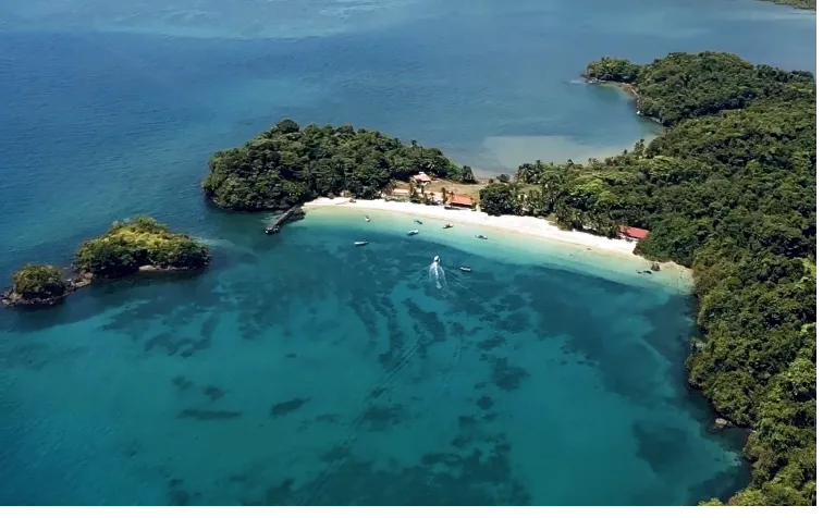 Boat arriving to a pristine beach in Coiba National Park, Panama