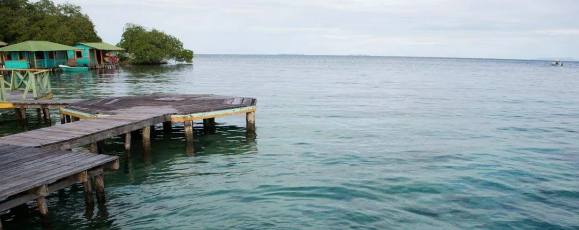 Wooden pier and stilt cabins over turquoise Caribbean water in Bocas del Toro, Panama
